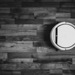 Robot Vacuum Cleaner - grayscale photo of round frame on wooden floor